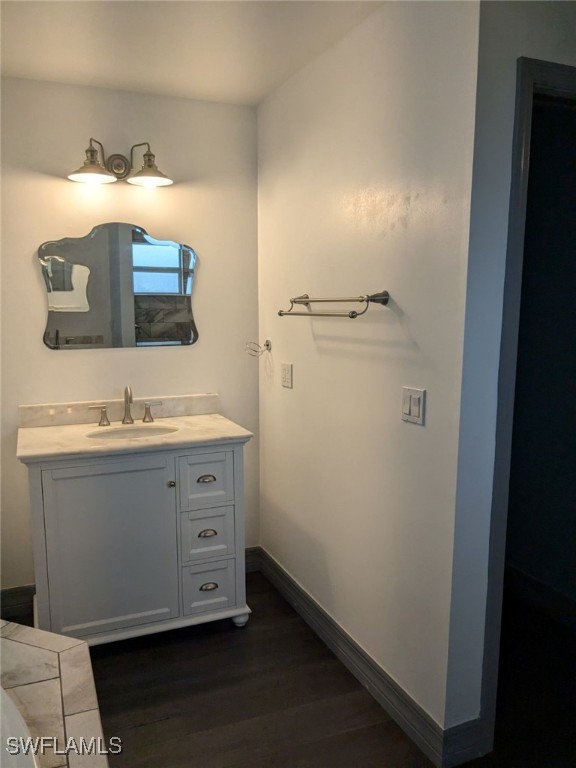 bathroom featuring hardwood / wood-style flooring and vanity