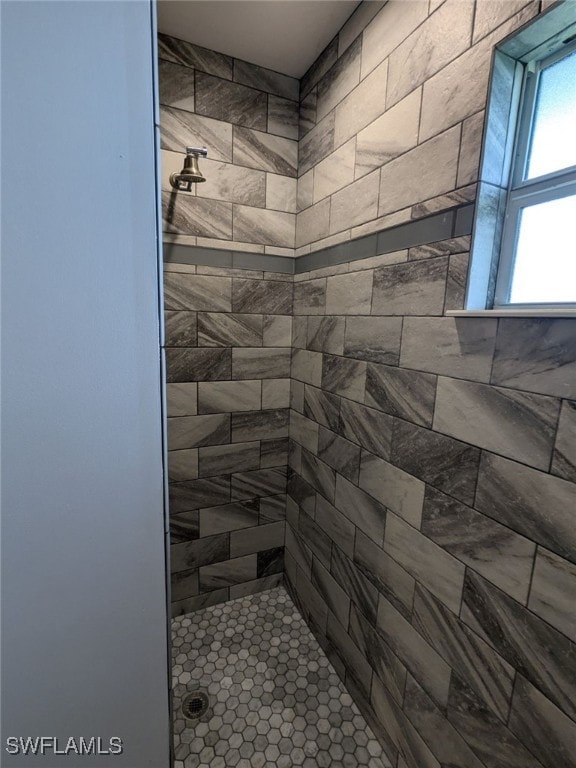 bathroom with a tile shower