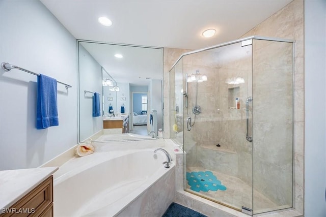 bathroom featuring vanity and separate shower and tub