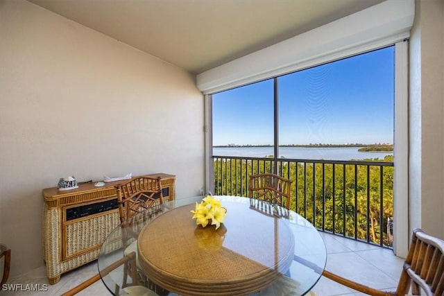 sunroom / solarium featuring a water view