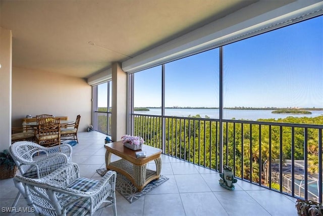 sunroom / solarium featuring a water view