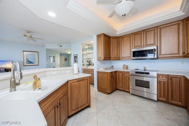 kitchen featuring appliances with stainless steel finishes, ornamental molding, ceiling fan, sink, and light tile patterned floors