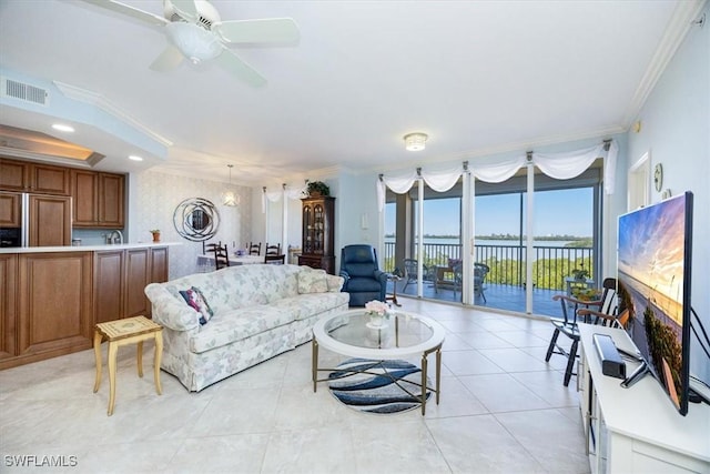 living room featuring crown molding, light tile patterned floors, and ceiling fan with notable chandelier