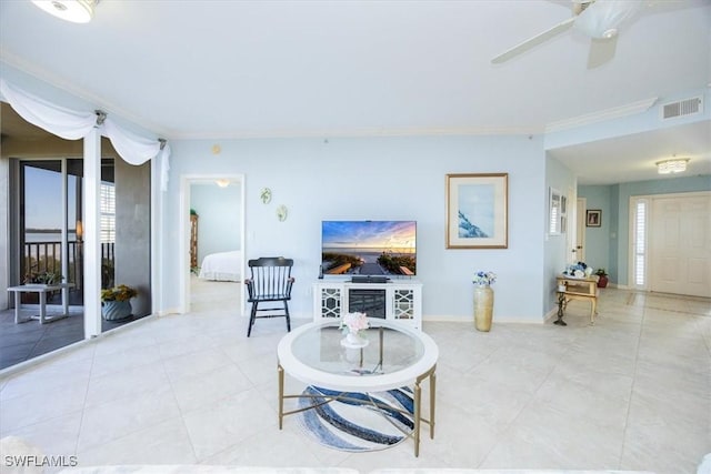 living room with crown molding and ceiling fan