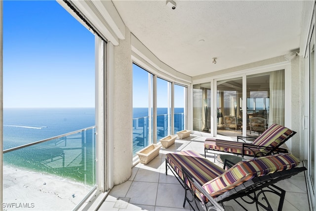 sunroom / solarium featuring a water view