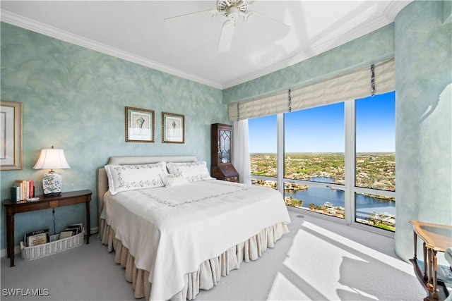 bedroom featuring carpet flooring, ceiling fan, crown molding, and a water view