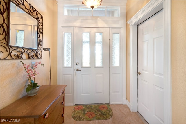 entryway with light tile patterned floors