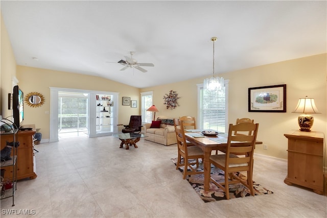 dining room with ceiling fan, plenty of natural light, and vaulted ceiling