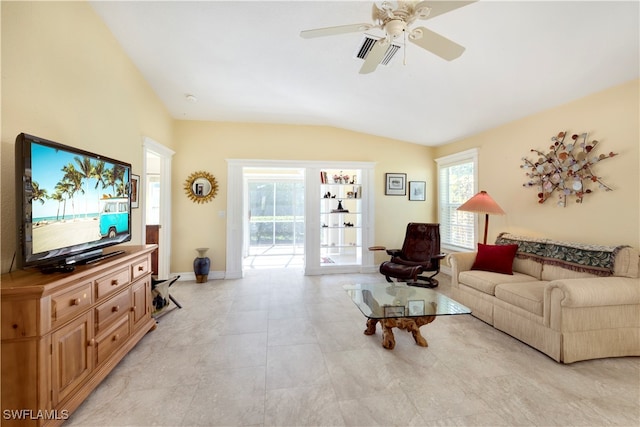 tiled living room with ceiling fan and vaulted ceiling