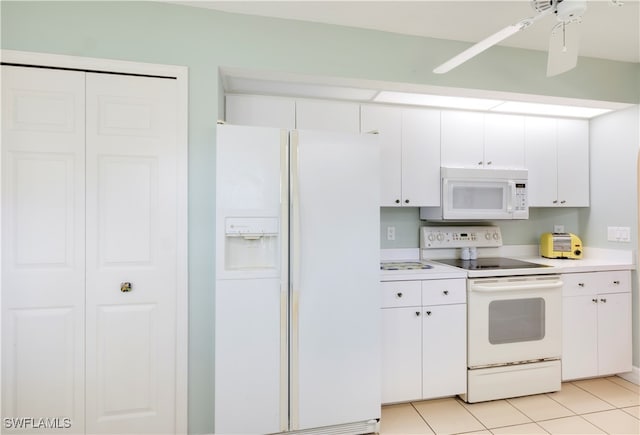 kitchen with white cabinets, light tile patterned floors, white appliances, and ceiling fan