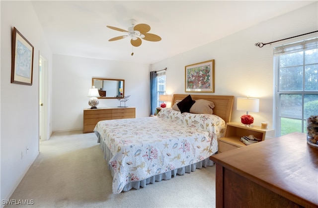 bedroom with light carpet and ceiling fan