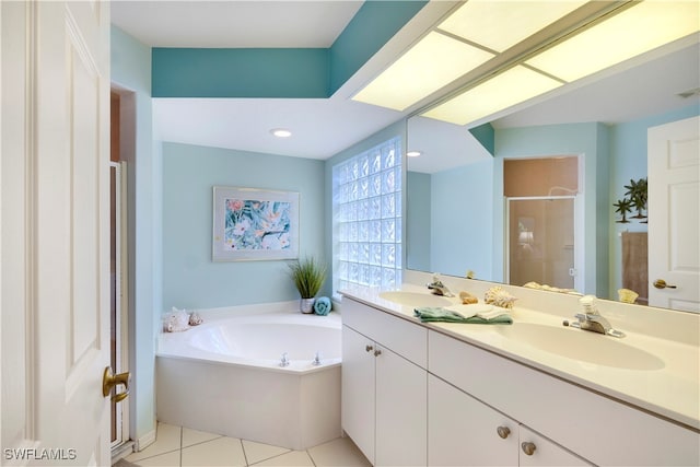 bathroom with tile patterned floors, separate shower and tub, and vanity