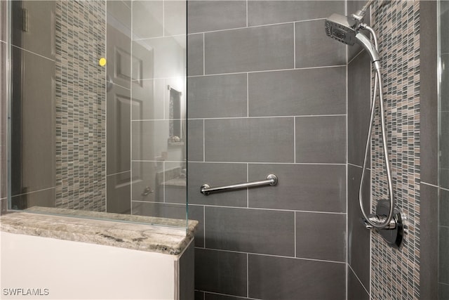 bathroom with tiled shower