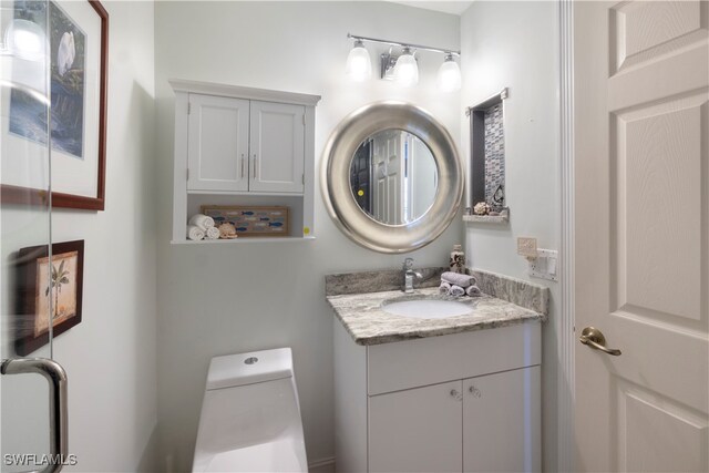 bathroom featuring vanity and toilet