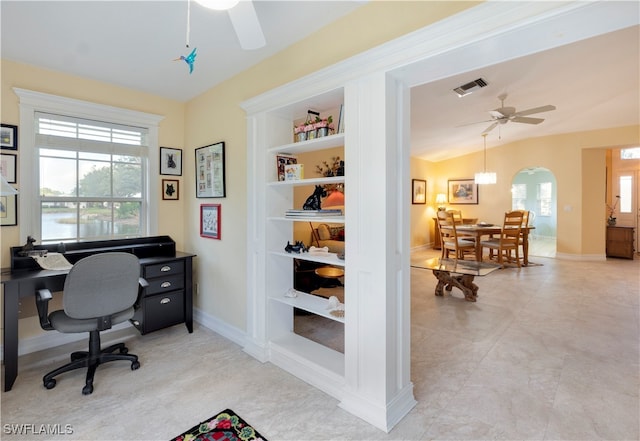 home office with ceiling fan, a healthy amount of sunlight, built in features, and vaulted ceiling