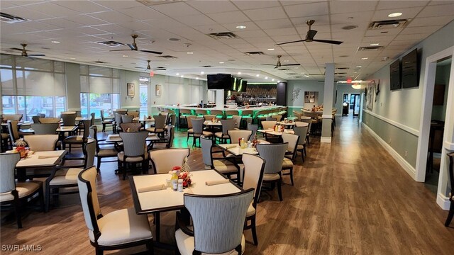 2050 Palo Duro Blvd, North Fort Myers, FL 33917 - dining room featuring ceiling fan, a drop ceiling, wood finished floors, and baseboards