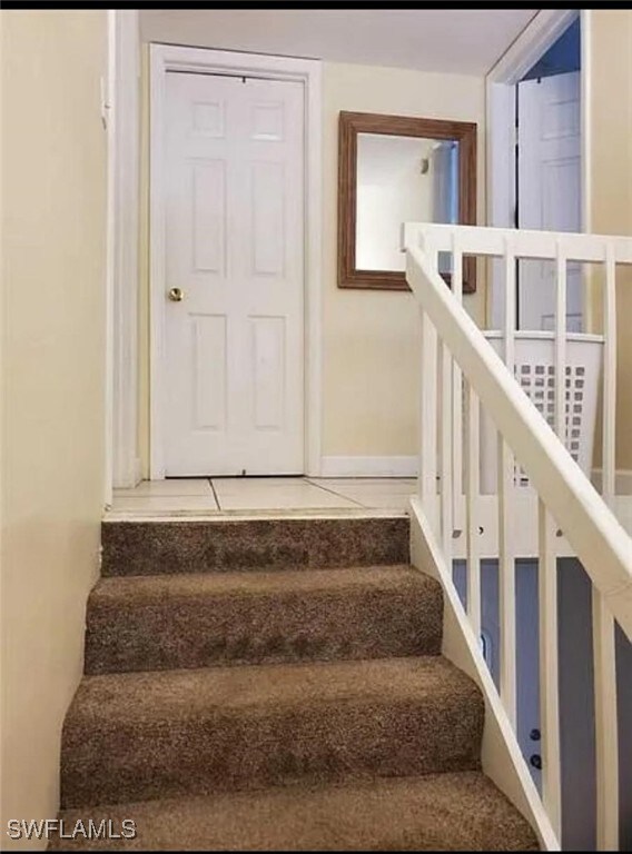 staircase featuring tile patterned floors