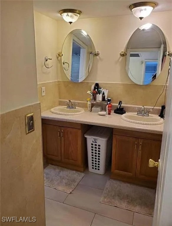 bathroom with tile walls, tile patterned flooring, and vanity