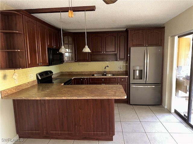 kitchen with hanging light fixtures, black appliances, decorative backsplash, sink, and kitchen peninsula