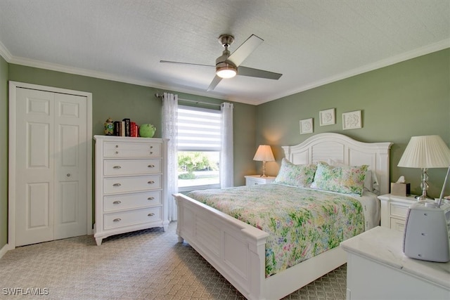 bedroom featuring a closet, crown molding, a textured ceiling, light carpet, and ceiling fan