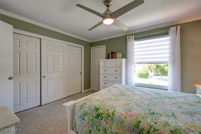 bedroom with a textured ceiling, light colored carpet, ceiling fan, and crown molding