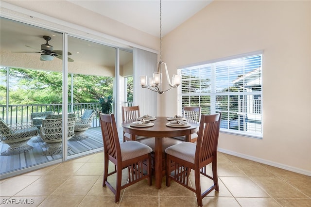 tiled dining area with ceiling fan with notable chandelier and vaulted ceiling