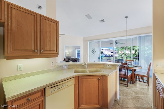 kitchen featuring dishwasher, kitchen peninsula, sink, light tile patterned floors, and pendant lighting