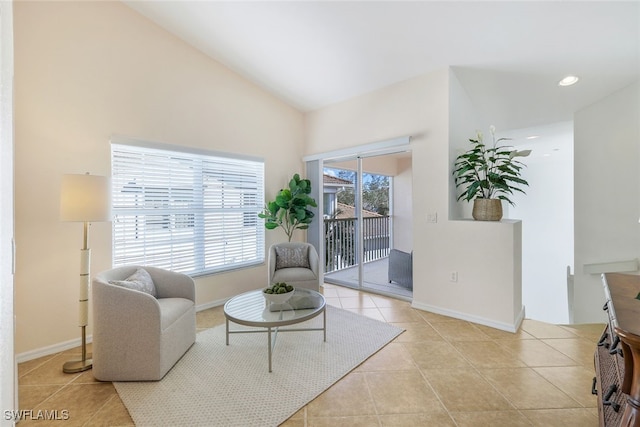 sitting room with light tile patterned floors and vaulted ceiling