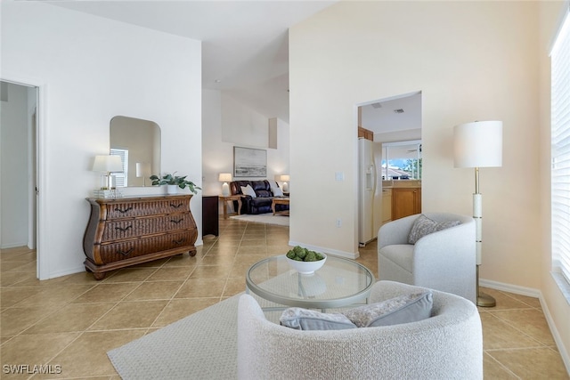 tiled living room featuring high vaulted ceiling