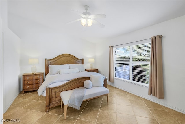 tiled bedroom featuring ceiling fan