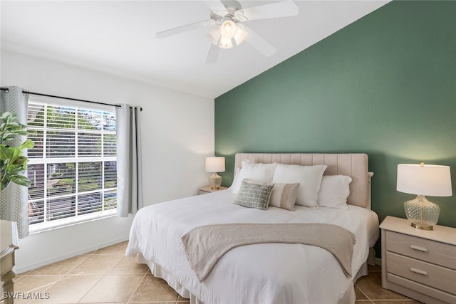 tiled bedroom featuring ceiling fan