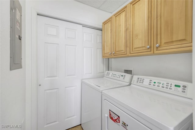 laundry area with electric panel, cabinets, and independent washer and dryer