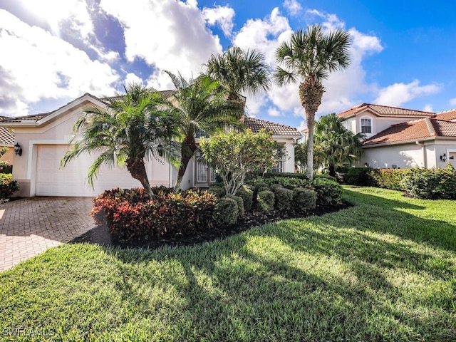 view of front of home with a front lawn and a garage