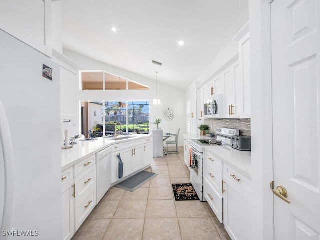 kitchen with lofted ceiling, white cabinetry, white appliances, and sink