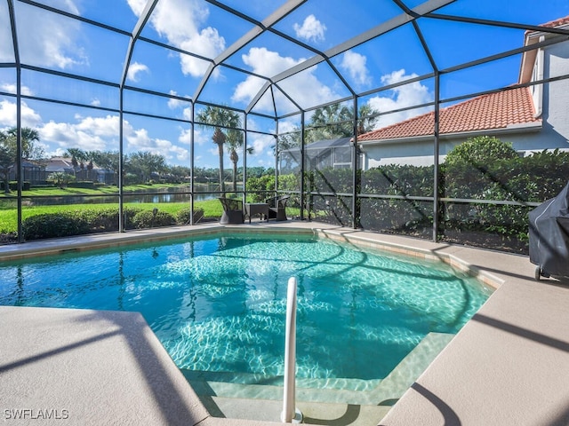 view of swimming pool with glass enclosure and grilling area