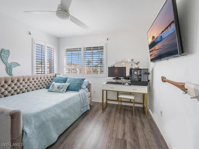 bedroom featuring multiple windows, dark hardwood / wood-style flooring, and ceiling fan