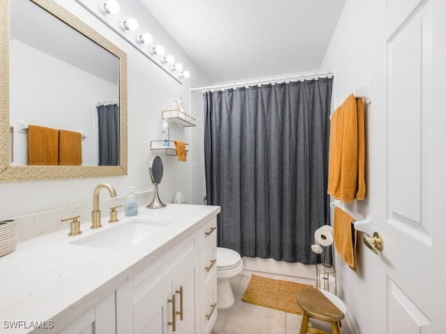 bathroom with tile patterned flooring, vanity, and toilet