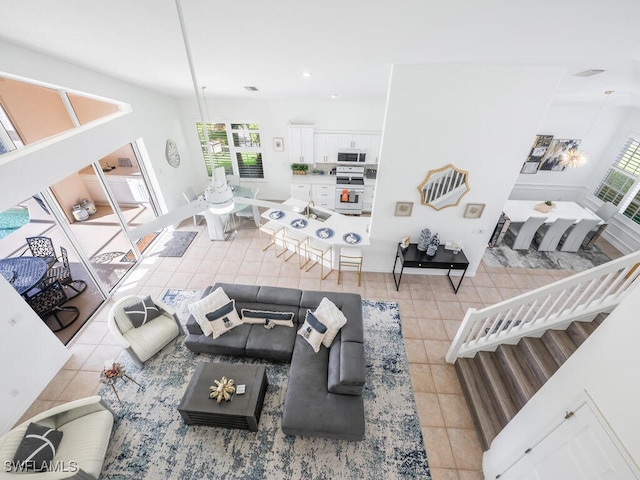 living room featuring plenty of natural light and light tile patterned flooring