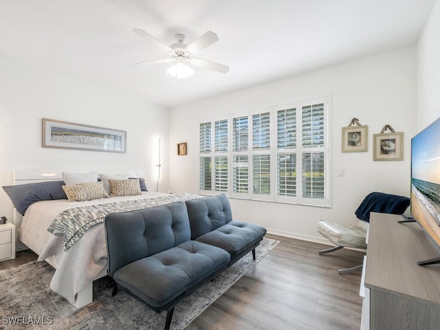 bedroom with ceiling fan and dark hardwood / wood-style floors