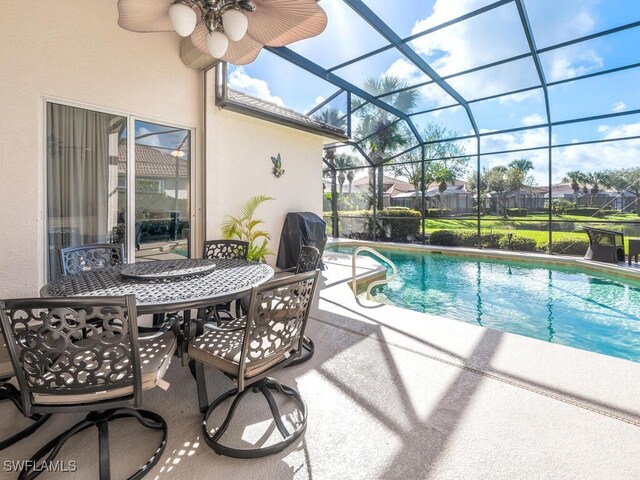 view of pool with a lanai, ceiling fan, and a patio area