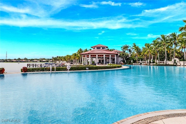 view of swimming pool featuring a water view