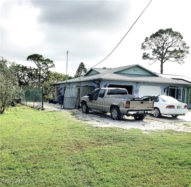 view of front facade with a front lawn and a garage