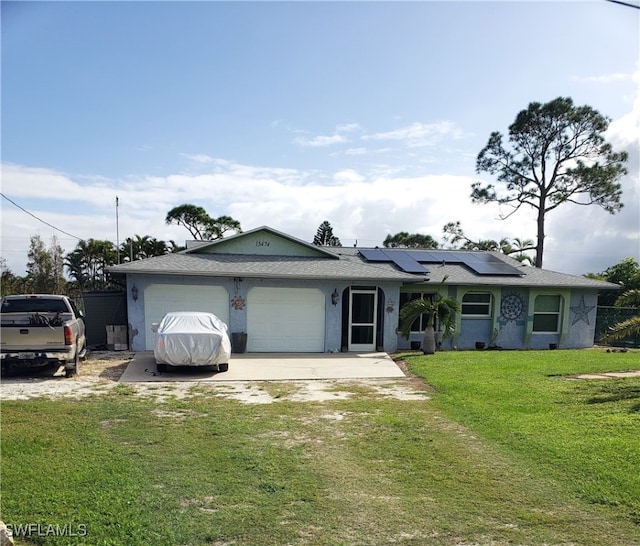 ranch-style home featuring solar panels, a front lawn, and a garage