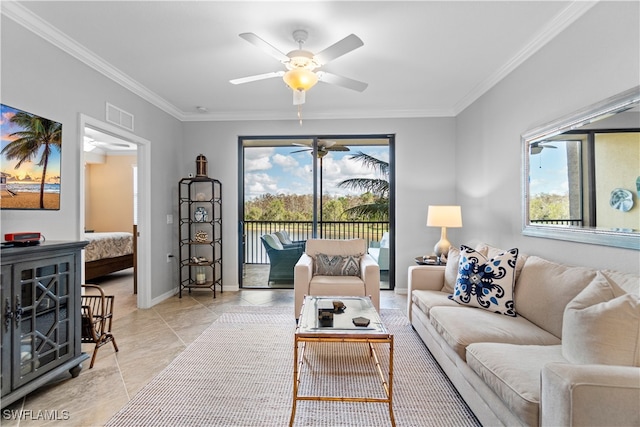 living room with a wealth of natural light, ceiling fan, light tile patterned floors, and ornamental molding