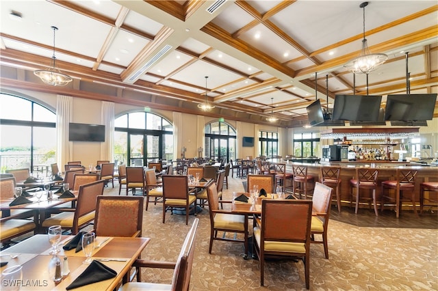 carpeted dining room with a towering ceiling, a chandelier, coffered ceiling, ornamental molding, and beam ceiling