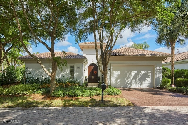 mediterranean / spanish-style home with a garage