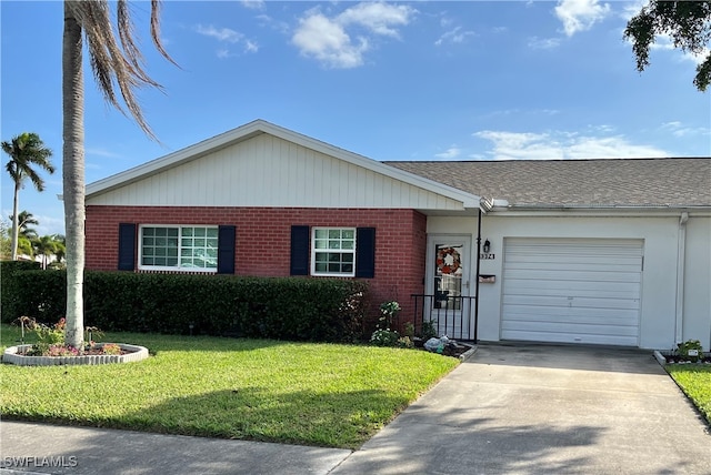 ranch-style house featuring a garage, driveway, brick siding, and a front yard