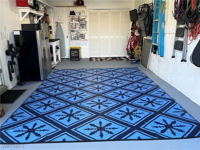 garage with stainless steel refrigerator