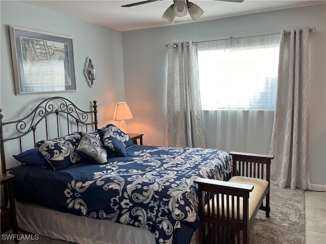 bedroom featuring ceiling fan and tile patterned flooring