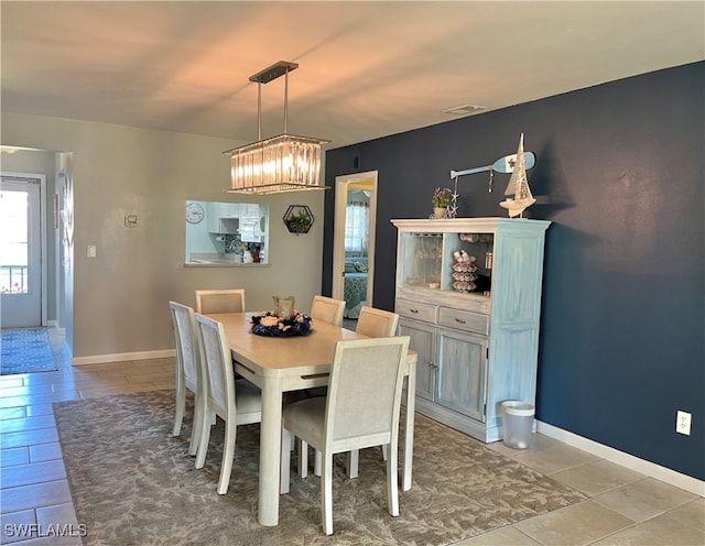 dining area with an inviting chandelier